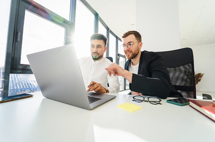Two multiracial male office workers, a Photo by borodai94