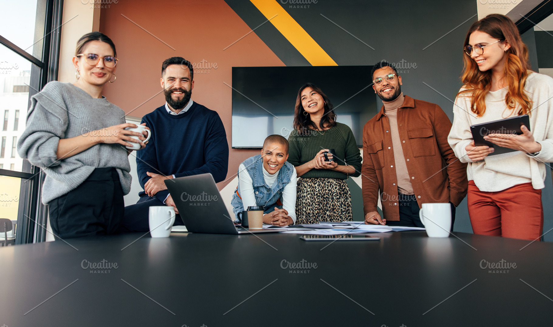 Young businesspeople smiling happily in a boardroom, a Person Photo by Jacob Lund