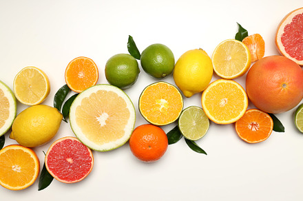 Citrus fruits with leaves on white background, a Food & Drink Photo by AtlasStudio