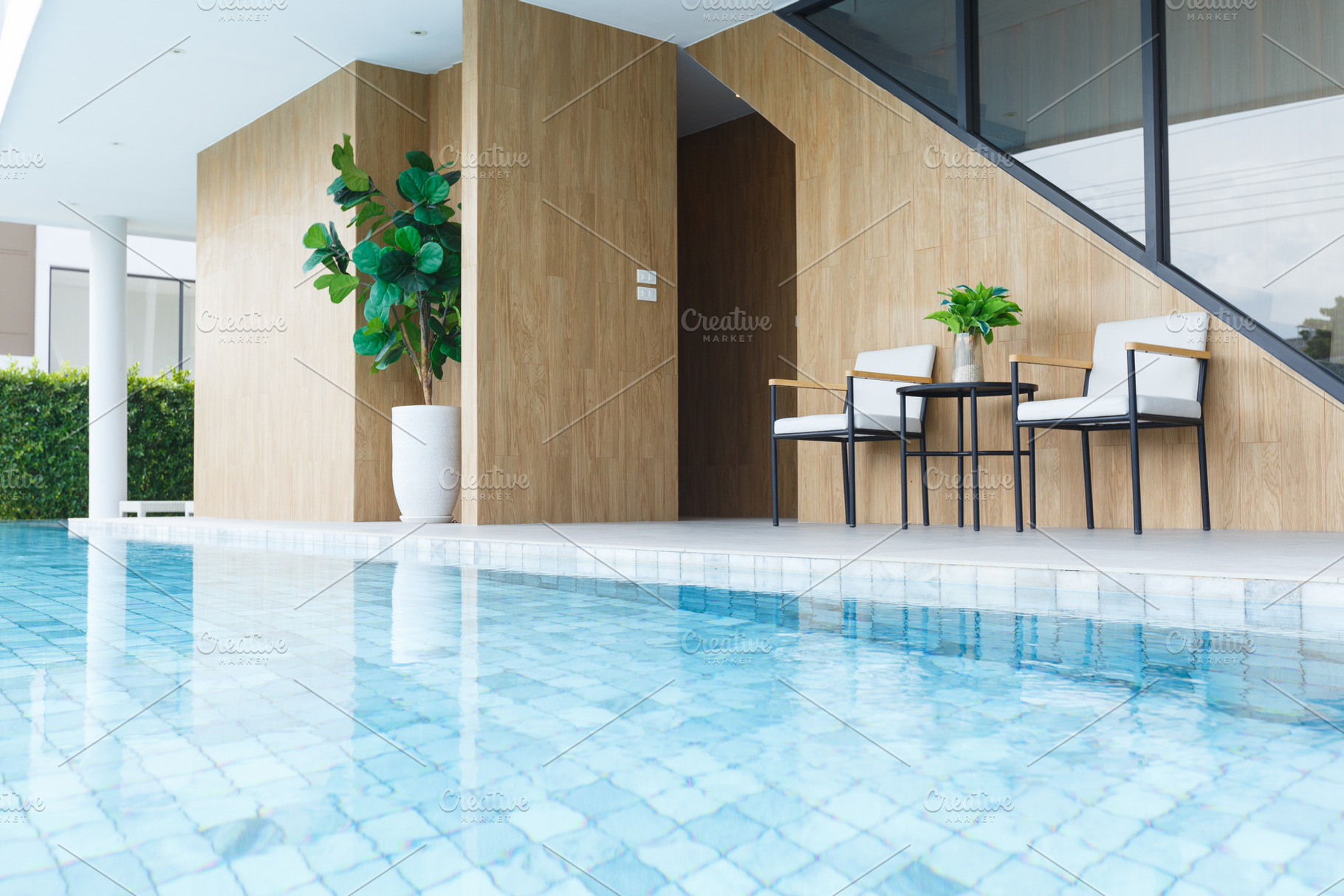 Modern poolside seating area with plants and wooden accents, an Architecture Photo by a454