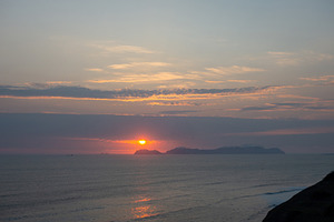 Sunset over the bay and Isla San Lorenzo in Lima, Peru, a Photo by GoodGoods