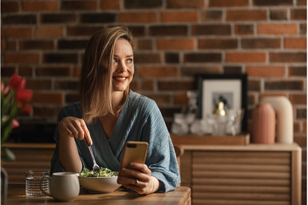 Young woman eating salad and, a Food & Drink Photo by HalfPoint
