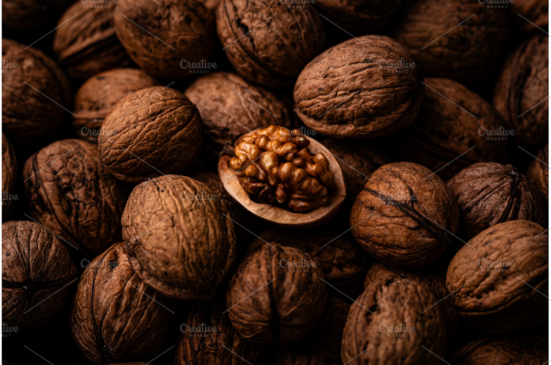 Cracked walnut among whole nuts, a Food & Drink Photo by Yulia Furman
