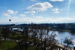 Scenic view of Krakow riverside with blue sky and trees in Europe, a Photo by AS photostudio