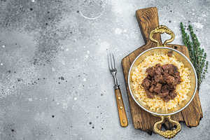 Kawurma qawurma layered over aromatic rice pilaf, highlighting s, a Food & Drink Photo by composter-box@mail.ru