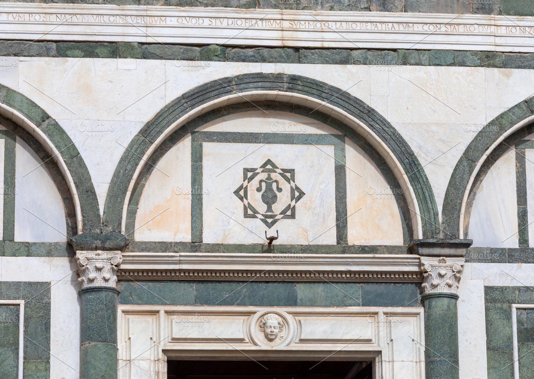 Detail of the Collegiata di Sant'Andrea facade showing marble decoration and la, a Photo by Antonio Gravante Market