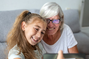 Happy Grandmother and Granddaughter Taking a Selfie with a Smartphone, a Person Photo by etorres69