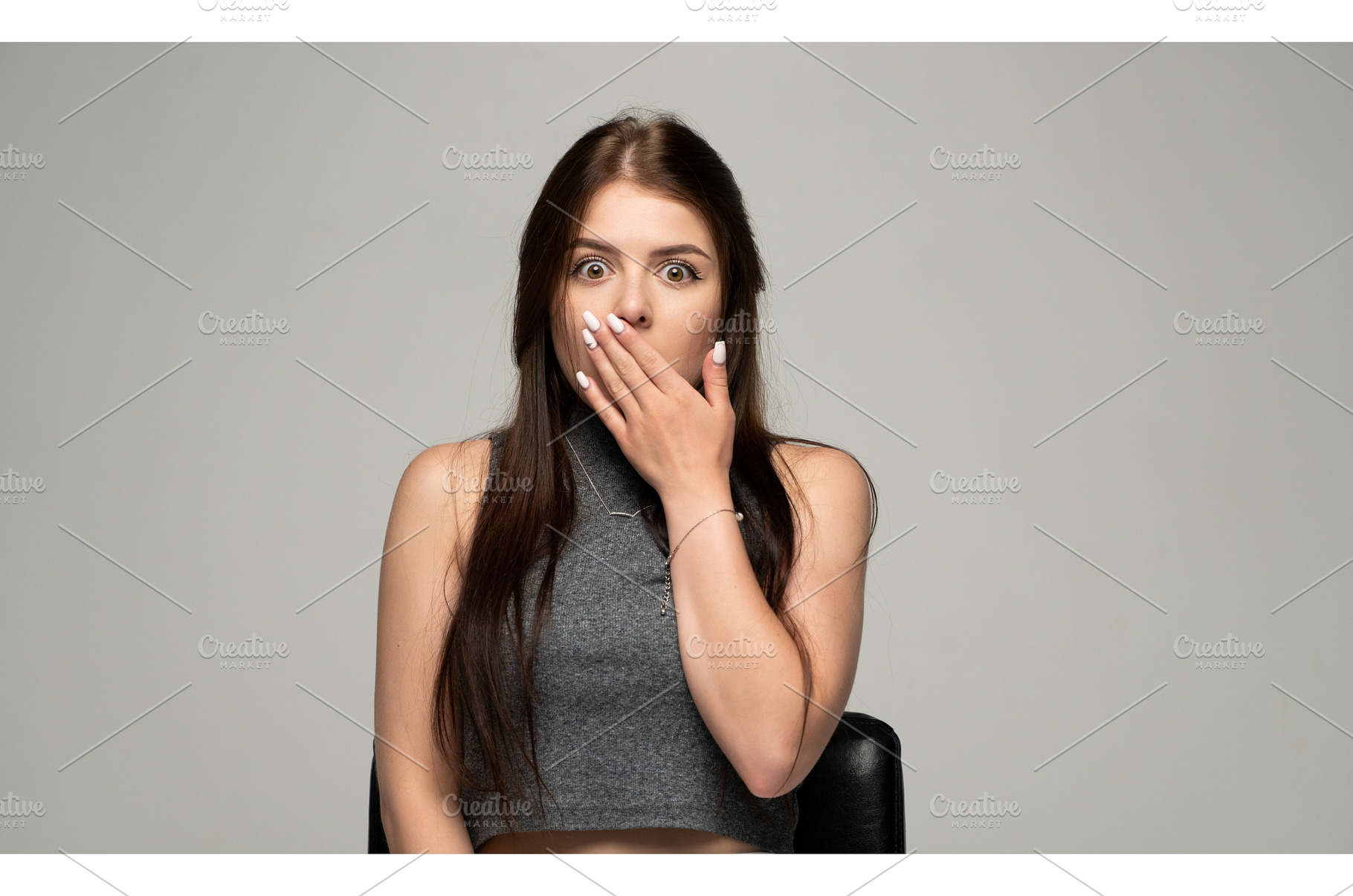 Woman gasping in surprise, covering, a Person Photo by volodymyrshtun13795