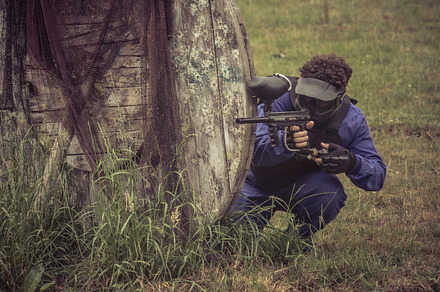Paintball containing paintball, gun, and boy