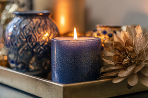 Burning indigo glitter candle creating hygge atmosphere with shi, a Photo by Studio ANNA