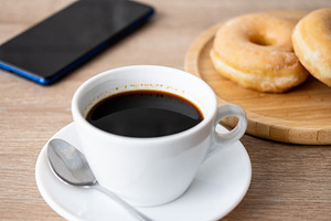 Black coffee with glazed donuts and smartphone, a Food & Drink Photo by etorres69