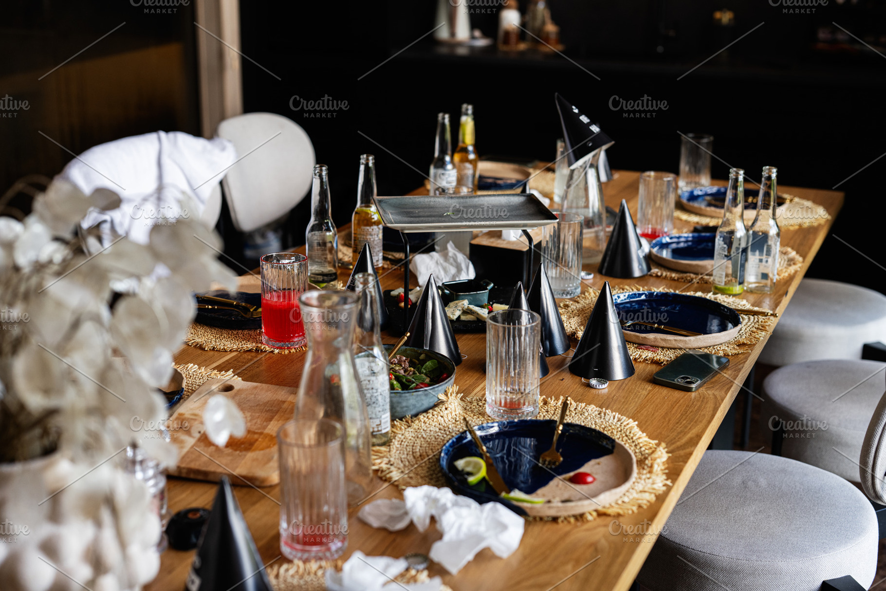 Casual party table with drinks and decorations after a lively gathering, a Photo by AS photostudio