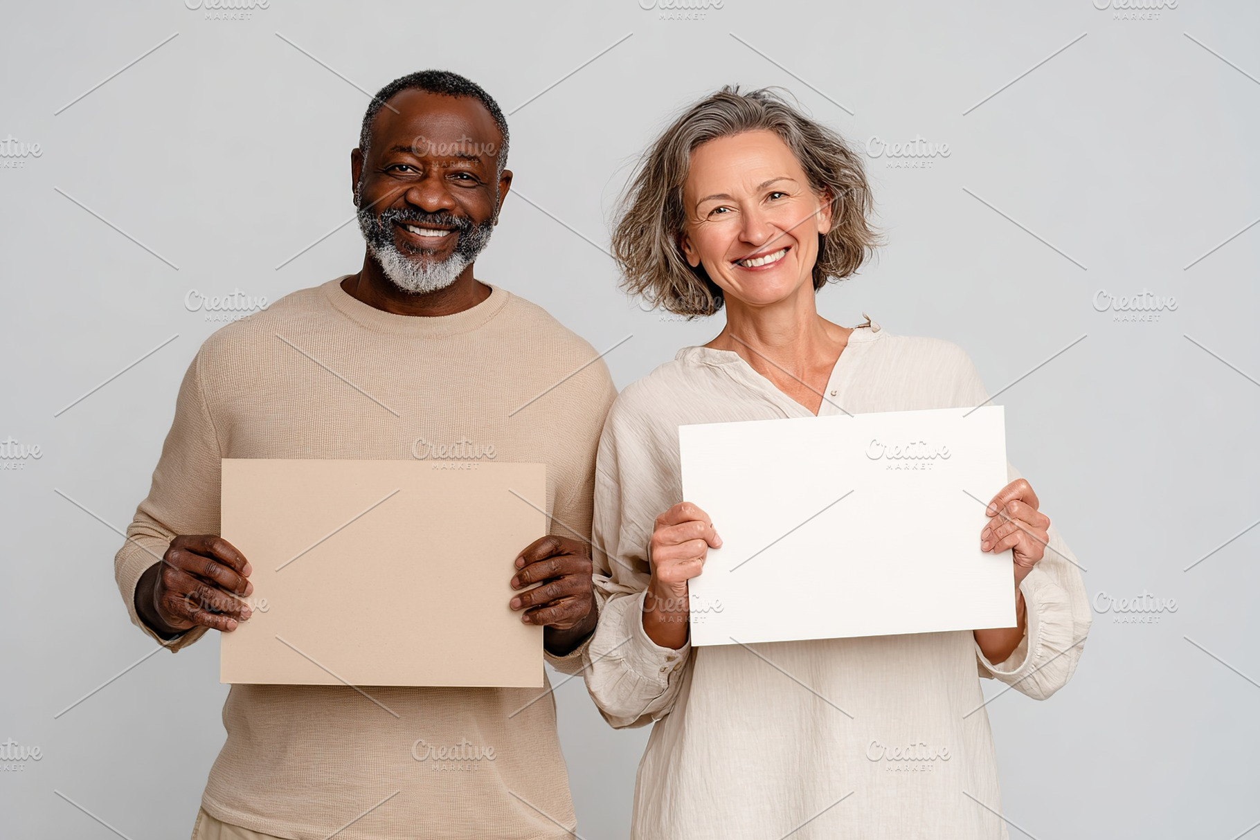 Happy couple holding blank signs in a light studio setting, a Photo by AlyaAnd