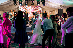 bride with bridesmaids dancing on dance floor in wedding, a Person Photo by Weddings, People, Travel