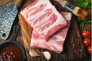Raw pork ribs with spices, salt and, a Food & Drink Photo by Budarinphoto