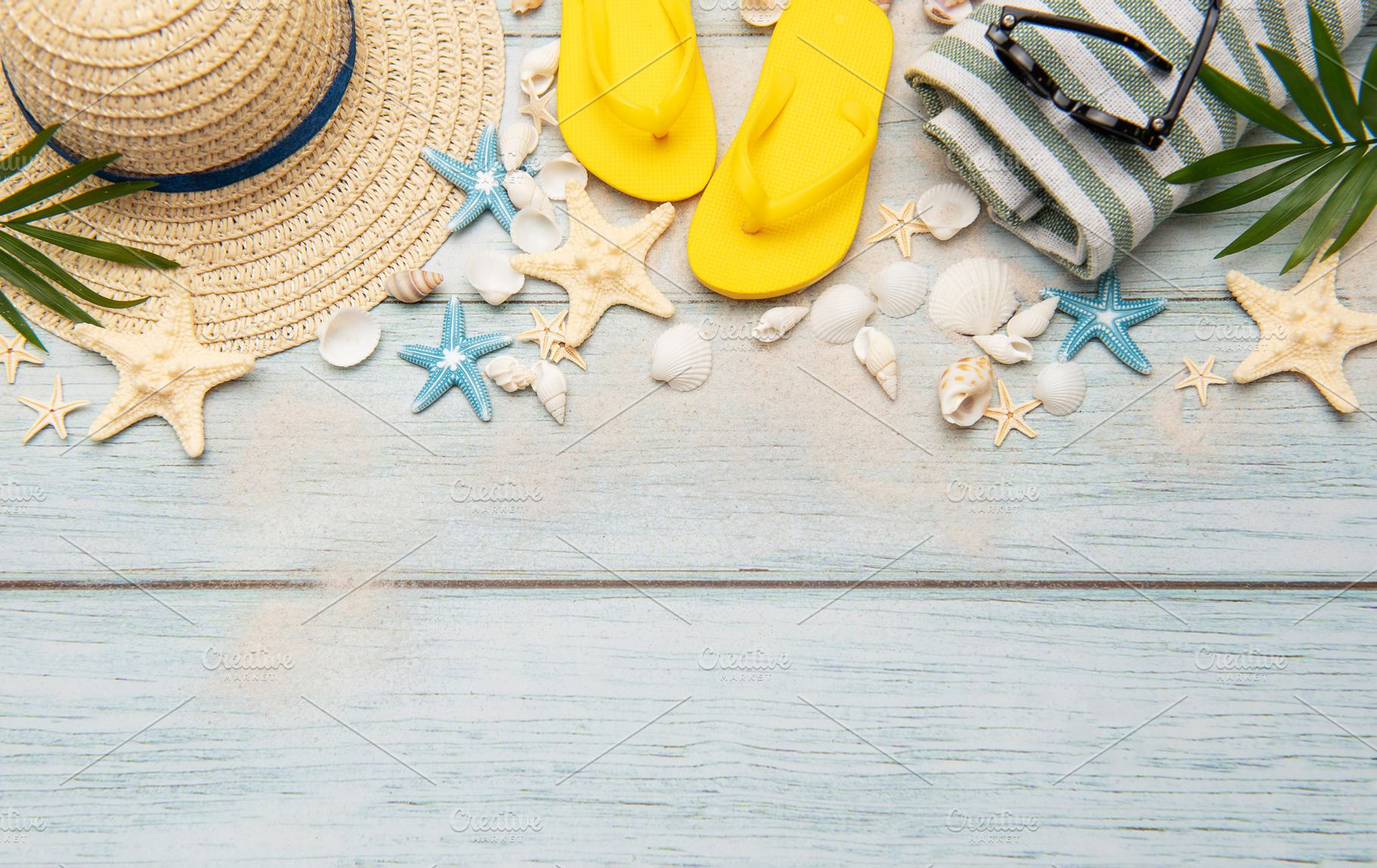 Summer accessories creating a frame on a wooden background with, a Holiday Photo by Olena Rudo
