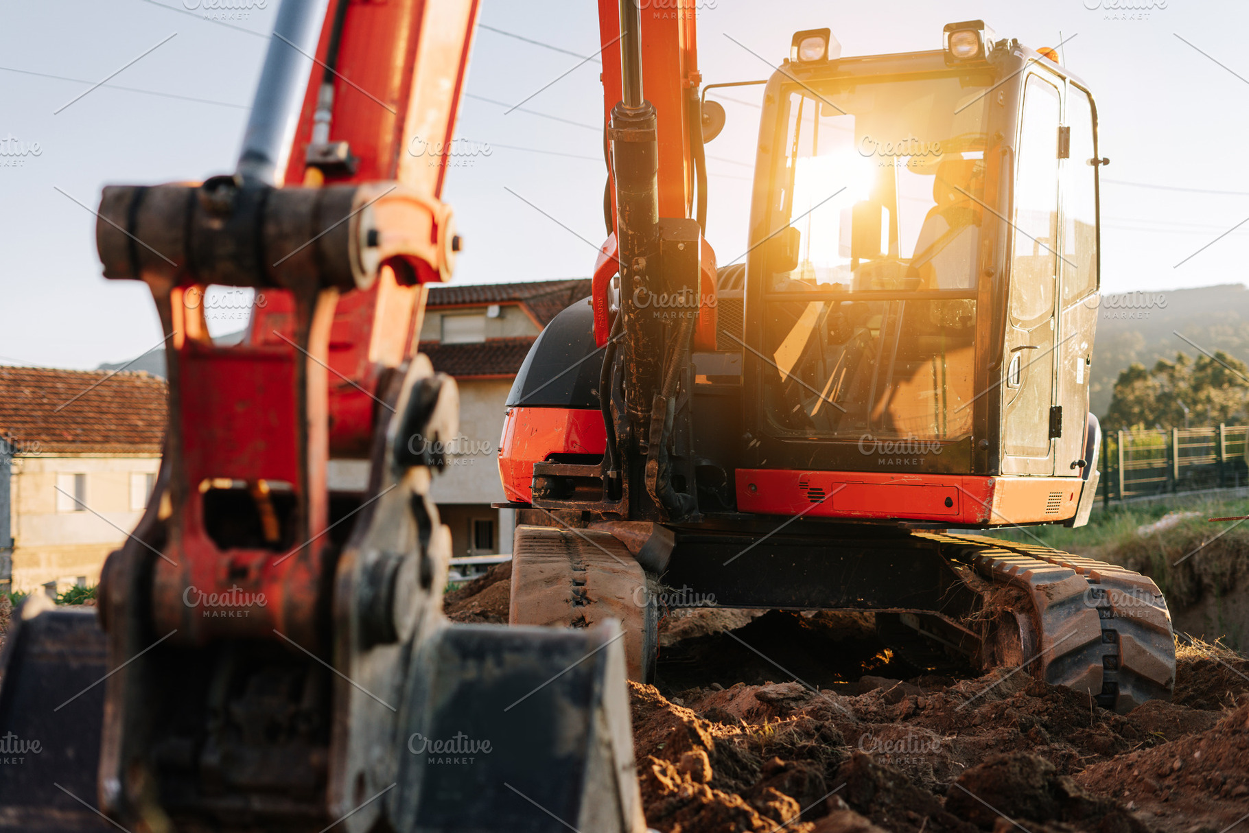 Backhoe excavator on a construction site, an Industrial Photo by rubenchase