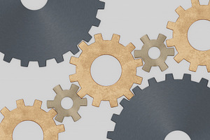 Interlocking metal gears on light industrial background, an Industrial Photo by RF Images