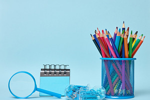 Set of office supplies including colored pencils in a glass, mag, a School & Education Photo by ndanko