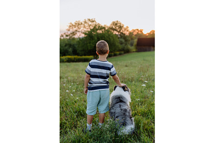 LIttle boy with his dog in the, an Animal Photo by HalfPoint