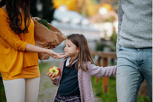 Young girl eating ripe apple during, a Person Photo by HalfPoint