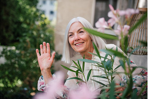 Beautiful senior neighbor waving at, a Person Photo by HalfPoint