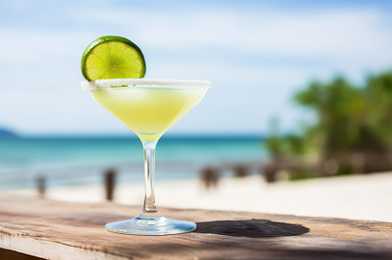 Glass of margarita cocktail on wooden bar table, a Food & Drink Photo by AlyaAnd