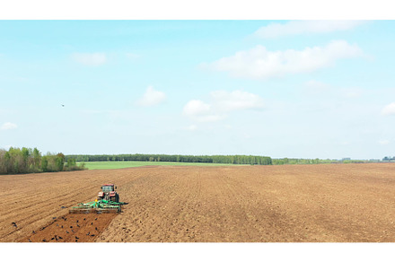 4K Aerial Flat View Tractor Plowing, an Industrial Photo by Our Amazing World