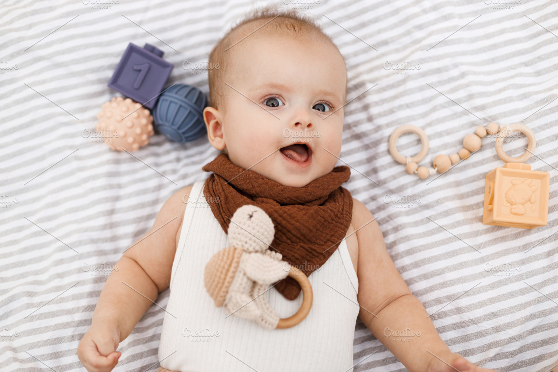 Beautiful happy baby lying on blanket with toys and teether in s, a Person Photo by Sonjachni