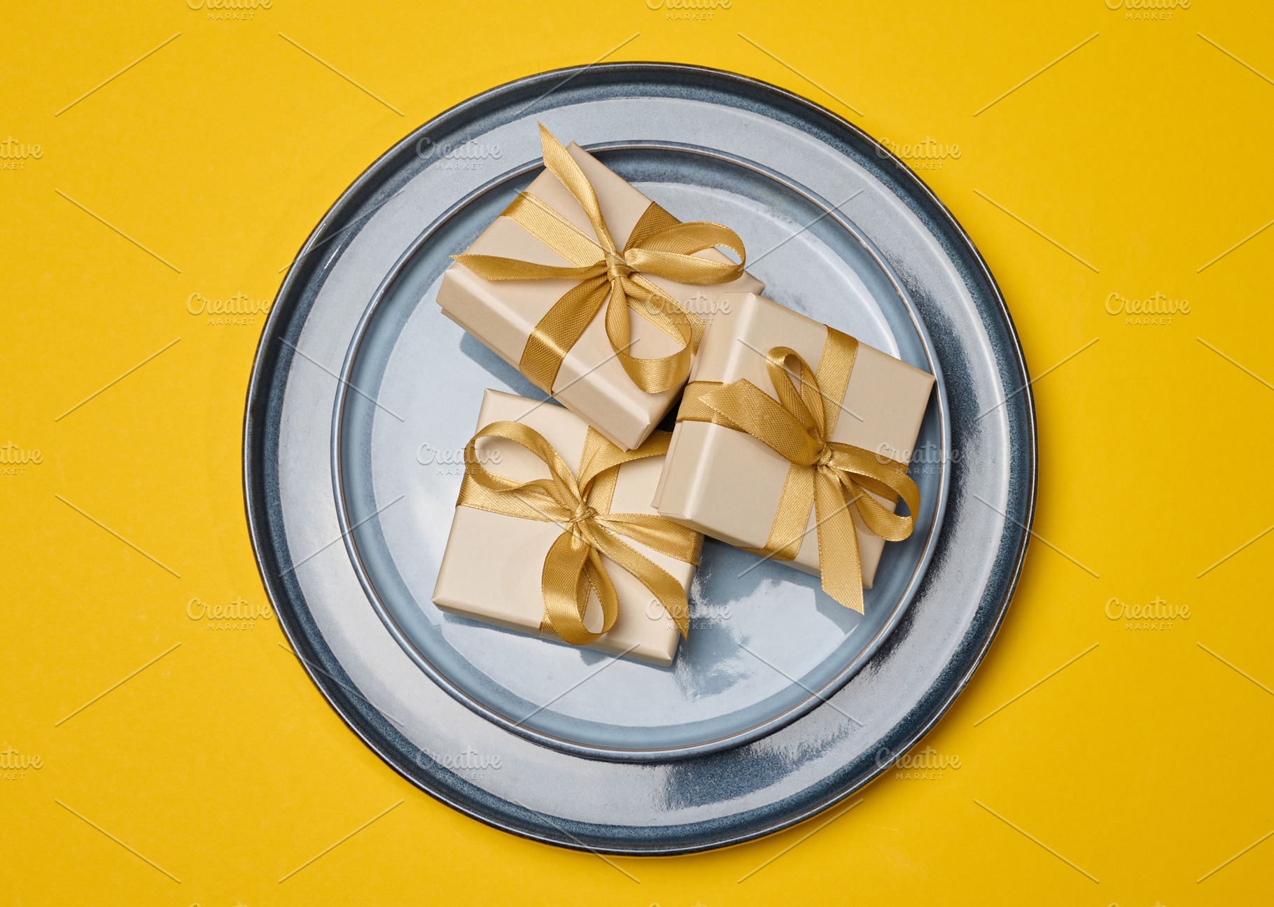 Gift boxes with gold bows on a white plate with a gold rim. A fe, a Food & Drink Photo by ndanko