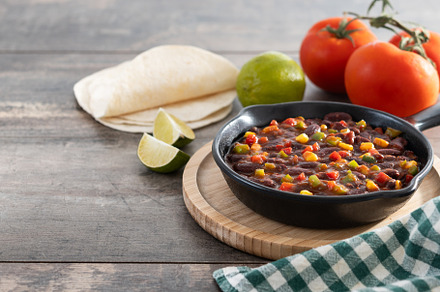 Mexican chilli beans with vegetables in iron pan