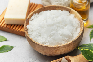 Magnesium flakes in a wooden bowl with soap, towel and essential, a Health & Medical Photo by Olena Rudo