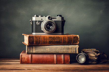 Vintage camera and books on a wooden, a Photo by Iftikhar Alam