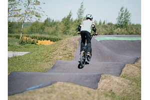 Pump track. Child on bmx bike rides, a Sports & Recreation Photo by Fascinadora