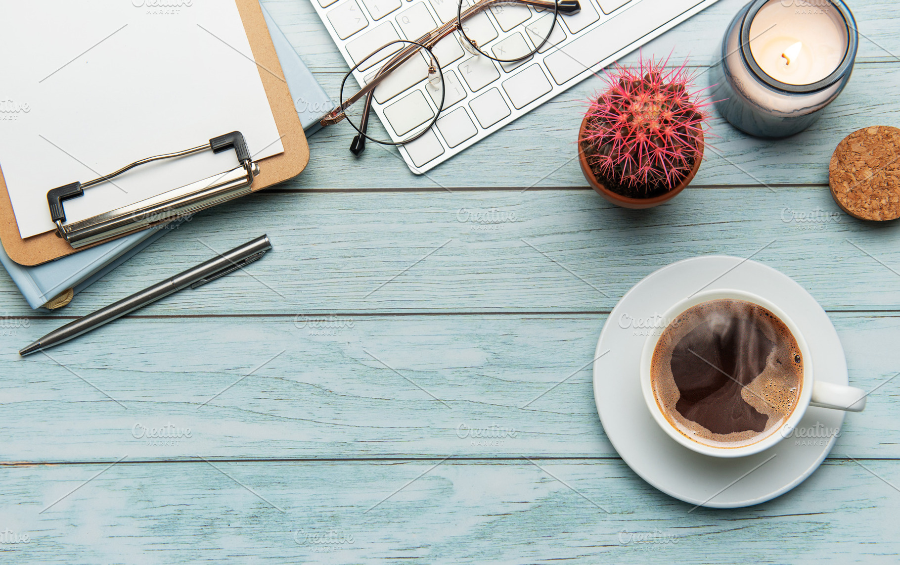 Office desk with coffee, keyboard, and supplies on light blue wo, a Business Photo by Olena Rudo