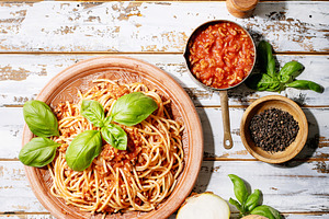 Cooked spaghetti bolognese containing above, appetizing, and basil