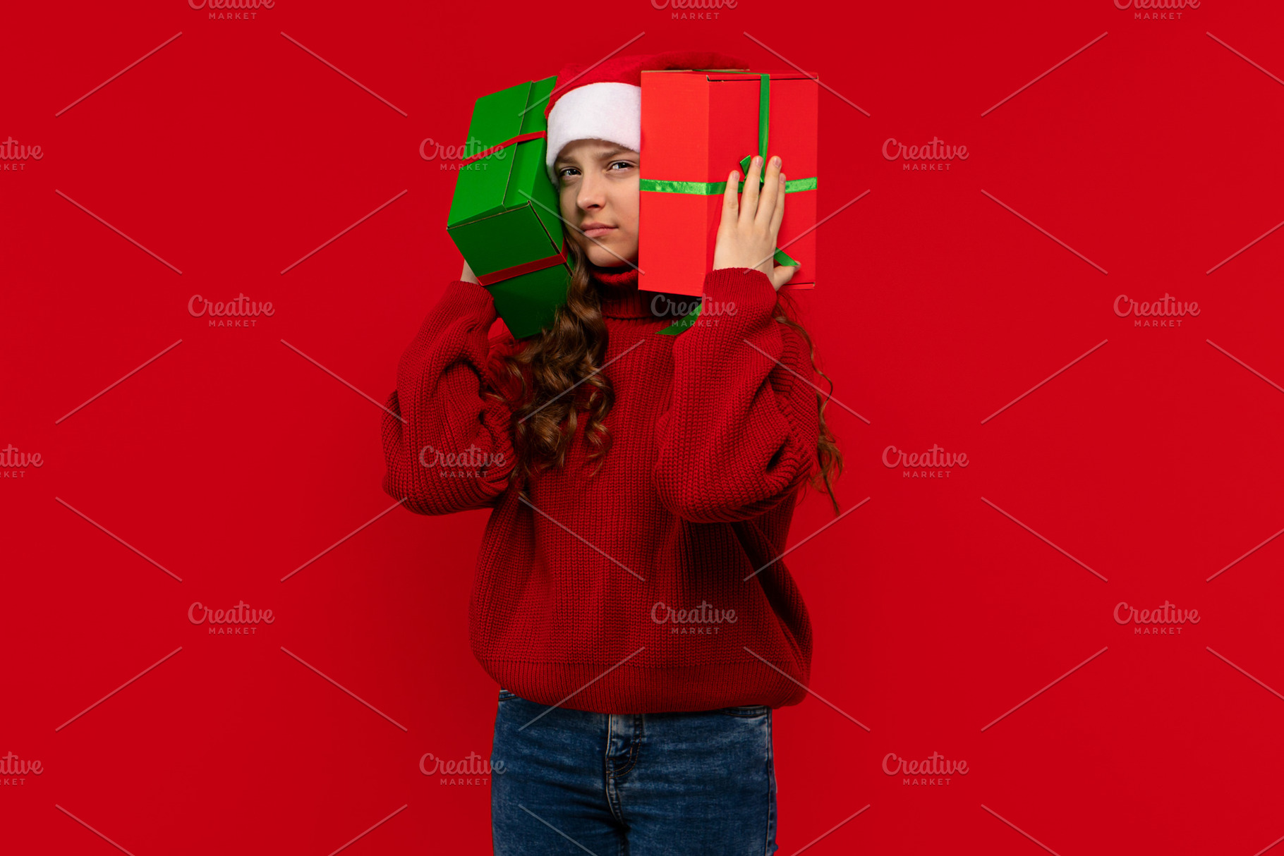 Girl in Santa hat holds gifts, a Holiday Photo by Elena Vagengeim
