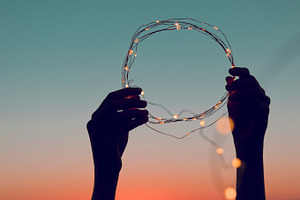 Hands holding a circle of lights 
