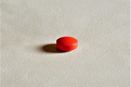 Single red pill casting a shadow on, a Health & Medical Photo by Ylivdesign