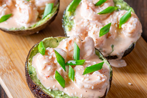 Avocado halves filled with guacamole, a Food & Drink Photo by Alexander Prokopenko