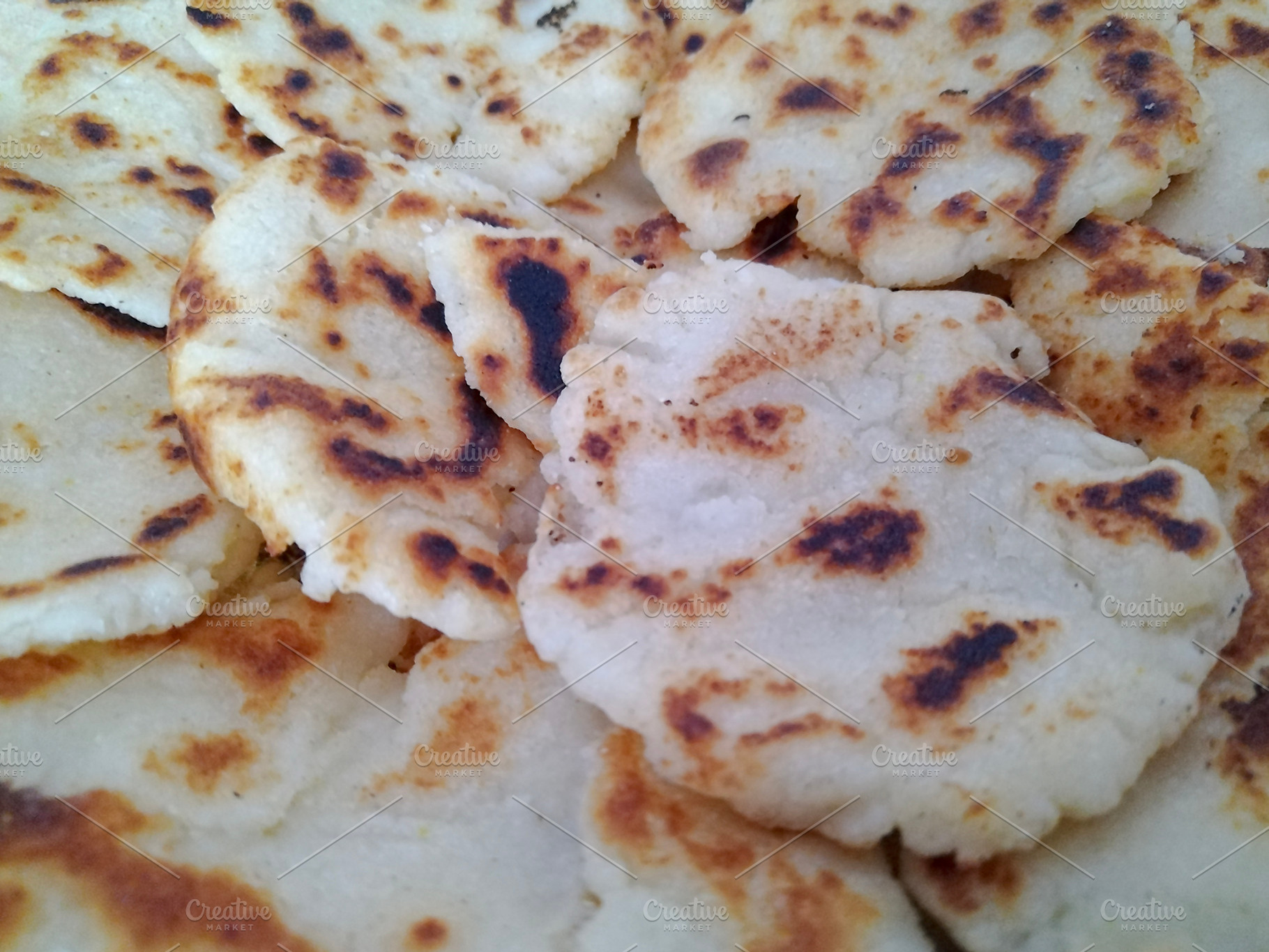 Close-up detail shot of many arepas, a Food & Drink Photo by DanFLCreativo