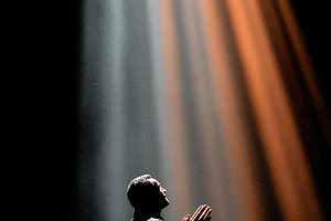Man Praying in Light Divine Rays Hop, a Photo by Pixeness Studio