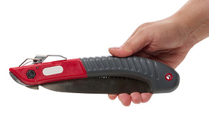 A person is holding a folding garden saw against an isolated bac, an Industrial Photo by ndanko