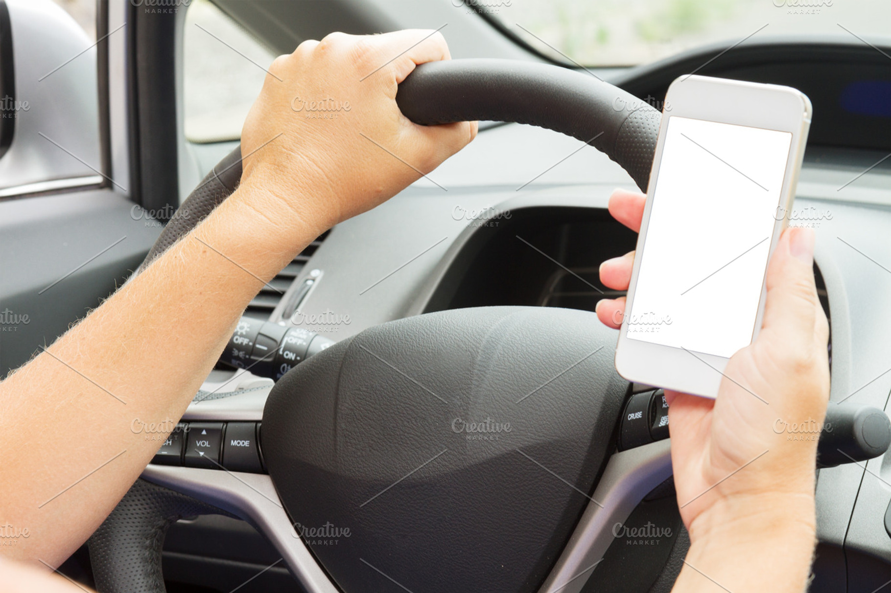 holding phone while driving a car, a Technology Photo by Neirfy