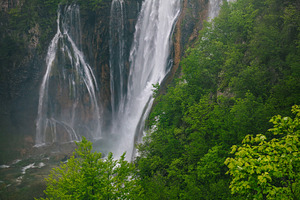 High waterfalls in the green forest, a Nature Photo by Alpine Dreams