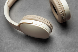 Wireless headphones resting on gray surface, a Technology Photo by Olena Rudo