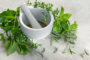 Mortar and pestle grinding fresh herbs for wellness, a Food & Drink Photo by Olena Rudo
