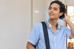 Young man using wearable cooling dev, a Photo by Dvoevnore photos