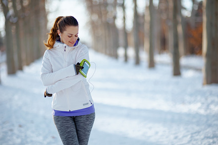 smiling fitness woman in white jacket with headphones, a Person Photo by Alliance Images