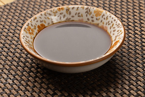 Small bowl containing soy sauce, a Photo by Grafvision photography